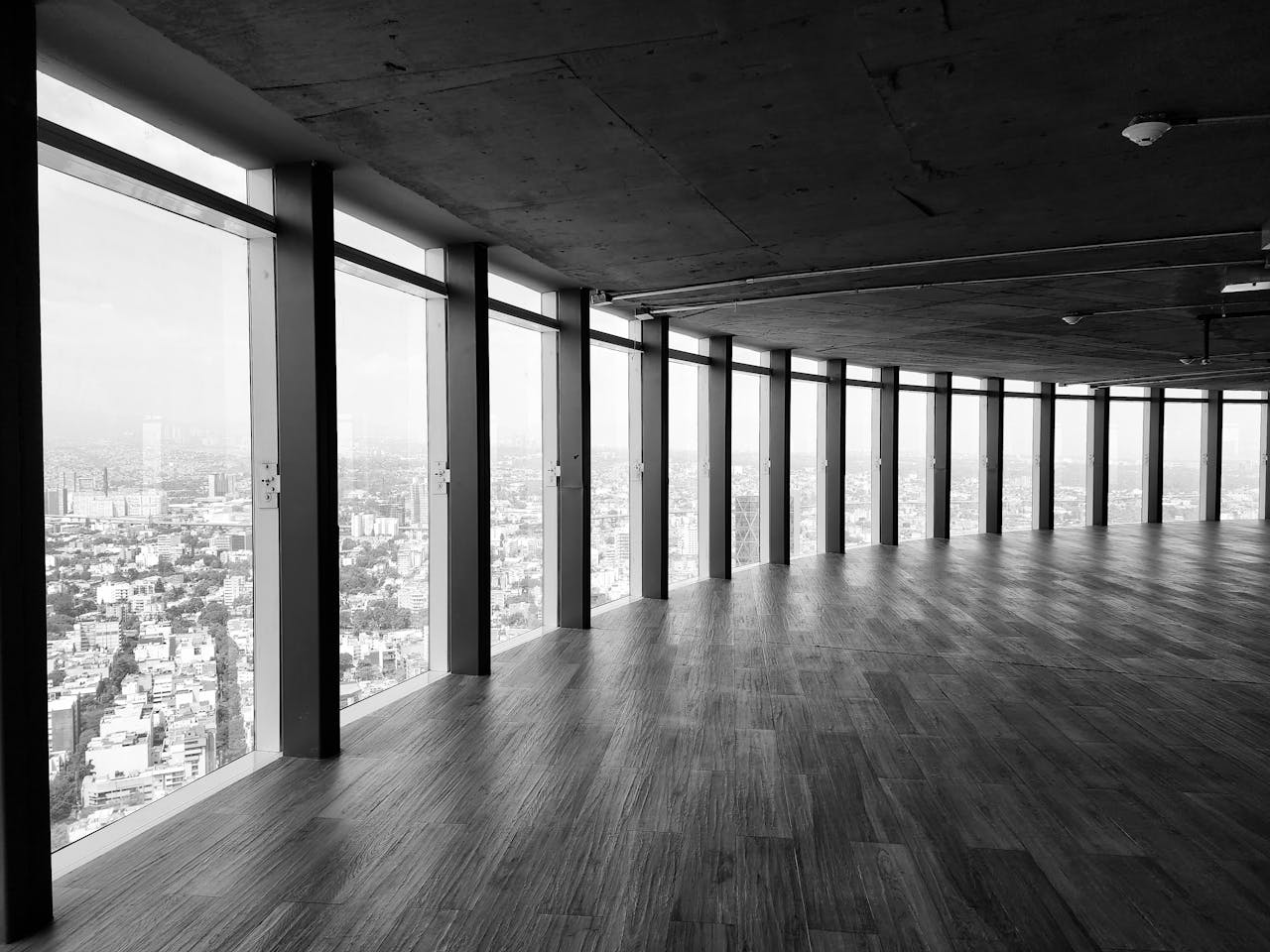 Spacious indoor view of a modern office with panoramic windows overlooking the city.